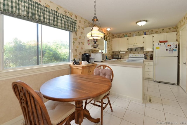 dining room featuring a textured ceiling, wallpapered walls, and light tile patterned floors