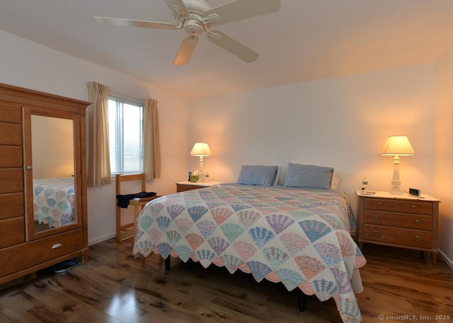 bedroom with baseboards, a ceiling fan, and dark wood finished floors