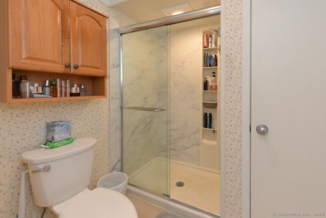 full bath featuring toilet and a stall shower