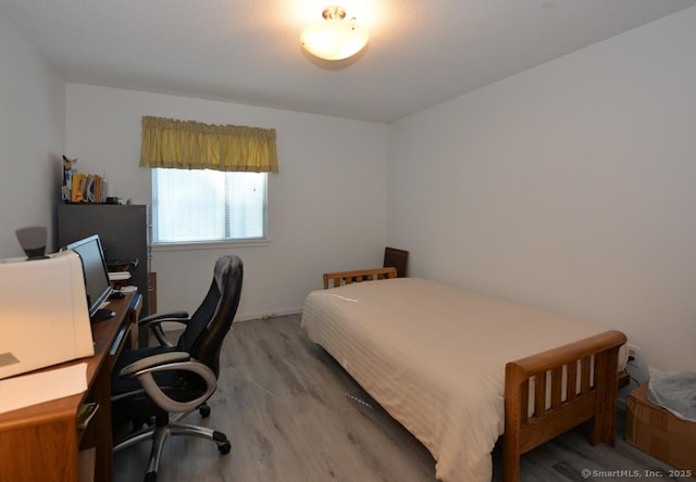 bedroom with wood finished floors