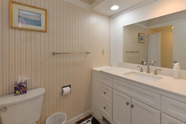 bathroom with visible vents, wallpapered walls, toilet, curtained shower, and vanity
