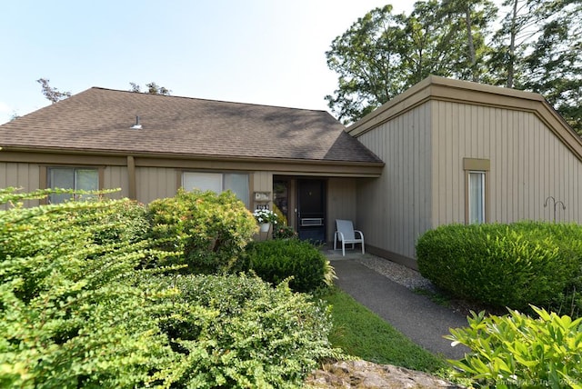 view of front of property featuring roof with shingles