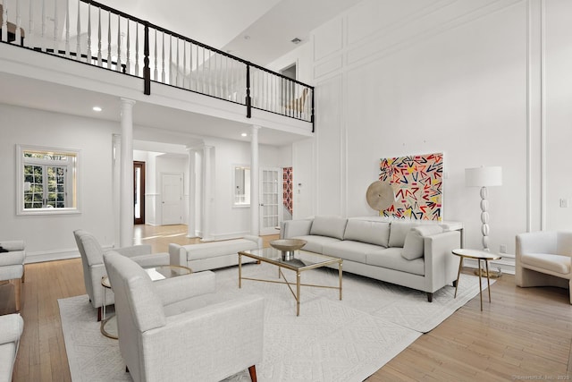 3 Mayflower Ln, Weston, CT 06883 - living area featuring ornate columns, a high ceiling, and light wood-style floors
