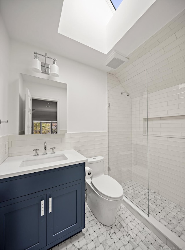 3 Mayflower Ln, Weston, CT 06883 - full bathroom featuring toilet, tile walls, a stall shower, and a wainscoted wall