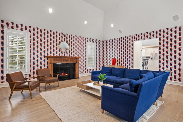3 Mayflower Ln, Weston, CT 06883 - living area with baseboards, wallpapered walls, a fireplace, light wood-style flooring, and visible vents