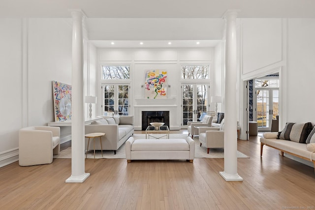 3 Mayflower Ln, Weston, CT 06883 - living room with light wood-style floors, a towering ceiling, and ornate columns