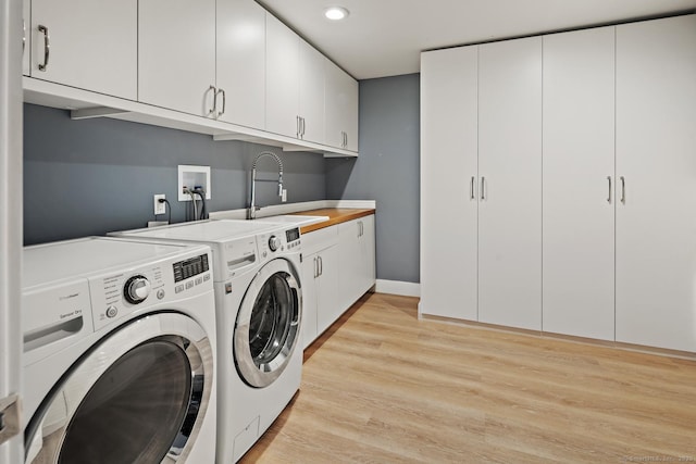 3 Mayflower Ln, Weston, CT 06883 - laundry area featuring light wood-type flooring, independent washer and dryer, a sink, and cabinet space