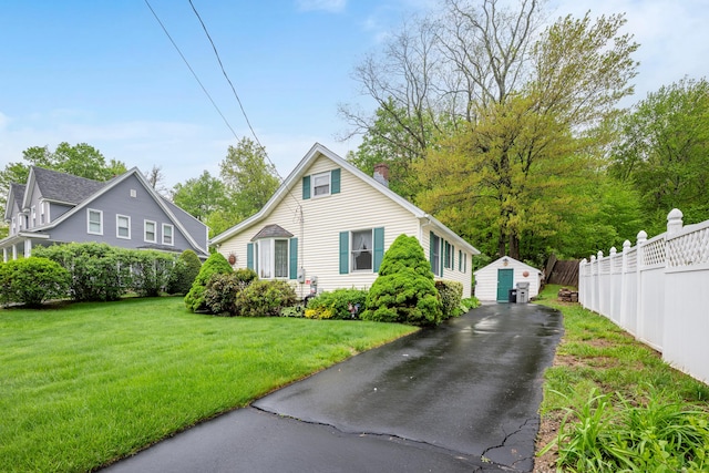 39 Smith St, Bristol, CT 06010 - view of front of home with a chimney, driveway, and a garage