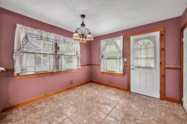 39 Smith St, Bristol, CT 06010 - entryway featuring healthy amount of natural light, a chandelier, wallpapered walls, a textured ceiling, and baseboards