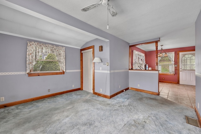 39 Smith St, Bristol, CT 06010 - empty room with carpet, baseboards, ceiling fan, vaulted ceiling, and a chandelier