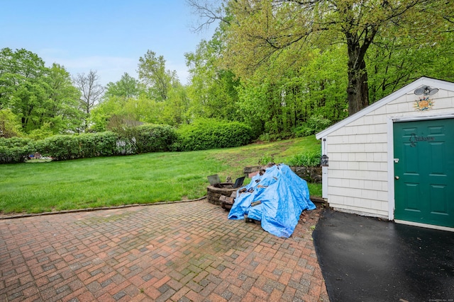 39 Smith St, Bristol, CT 06010 - view of patio featuring an outdoor fire pit, an outbuilding, and a storage shed