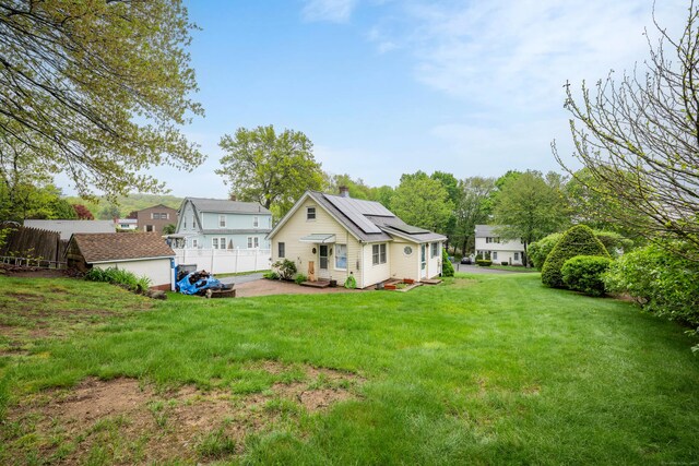 39 Smith St, Bristol, CT 06010 - back of house featuring an outdoor structure, a chimney, a patio, and entry steps