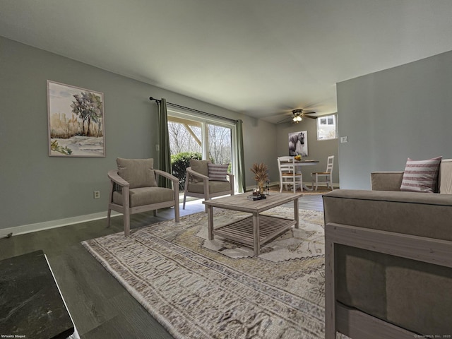 living room featuring plenty of natural light, baseboards, a ceiling fan, and wood finished floors