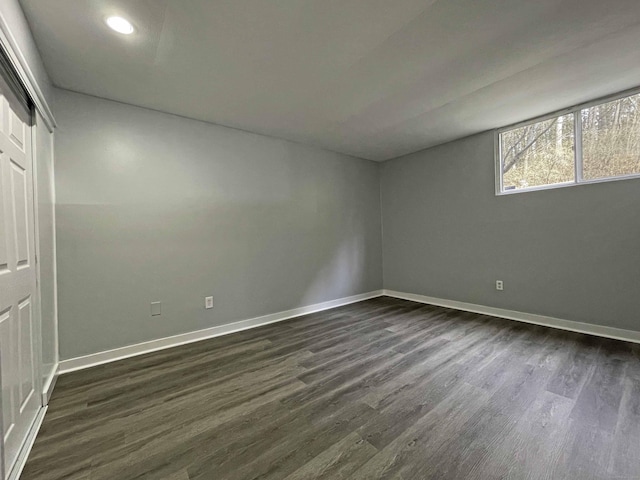 unfurnished bedroom with baseboards, recessed lighting, a closet, and dark wood-style flooring