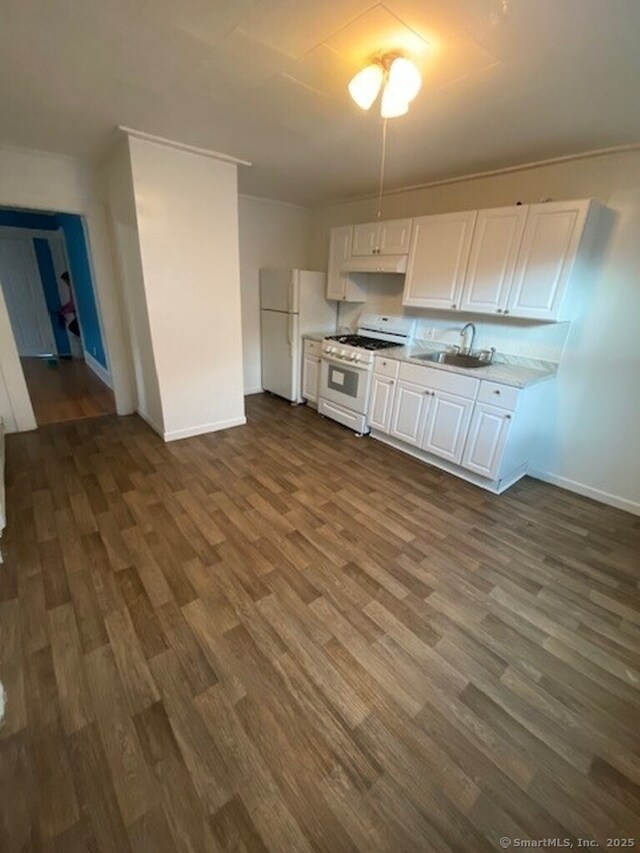 266 Willow St, Waterbury, CT 06710 - kitchen featuring white cabinets, light countertops, white appliances, dark wood-type flooring, and a sink