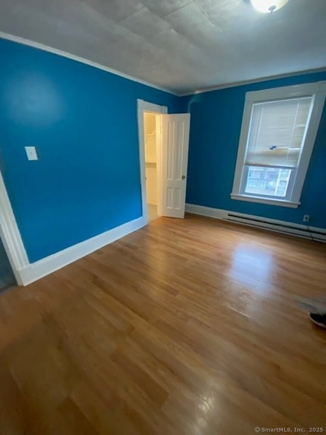 266 Willow St, Waterbury, CT 06710 - unfurnished room with baseboards, a baseboard heating unit, and wood finished floors