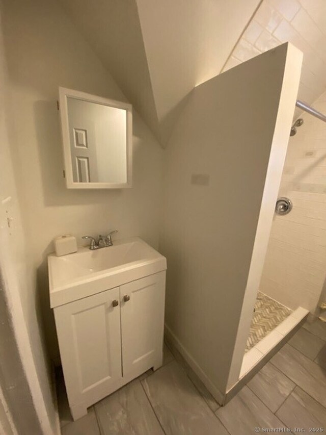 266 Willow St, Waterbury, CT 06710 - bathroom with vanity, a stall shower, and vaulted ceiling