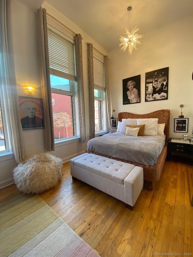 134 Washington St Apt 201, Norwalk, CT 06854 - bedroom featuring hardwood / wood-style floors, a chandelier, multiple windows, and baseboards