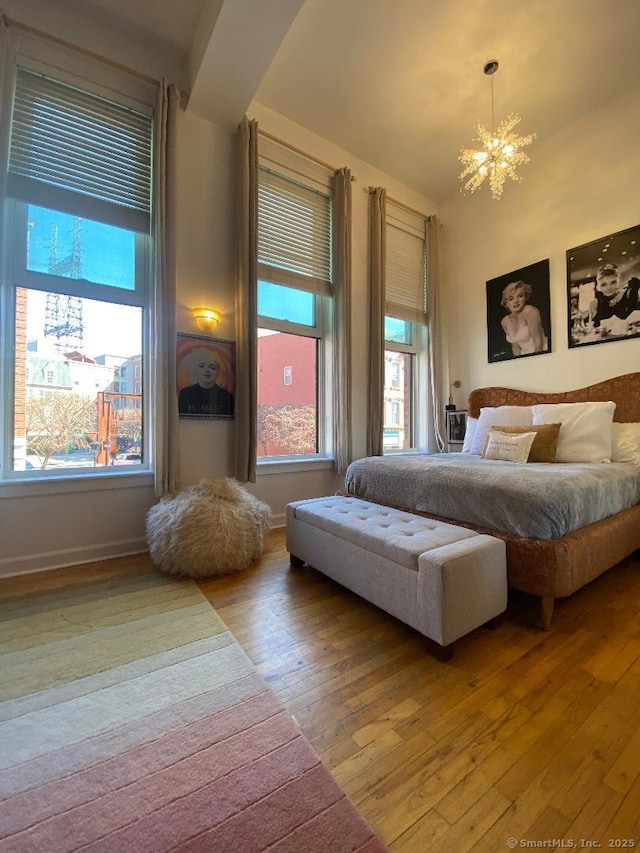 134 Washington St Apt 201, Norwalk, CT 06854 - bedroom featuring a chandelier, light wood finished floors, and baseboards
