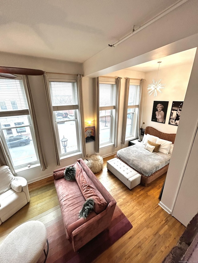 134 Washington St Apt 201, Norwalk, CT 06854 - bedroom with light wood-style floors, multiple windows, and a chandelier