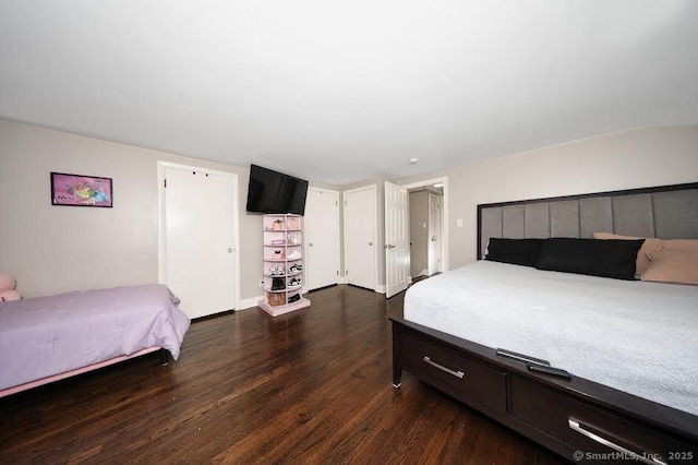 bedroom with dark wood finished floors
