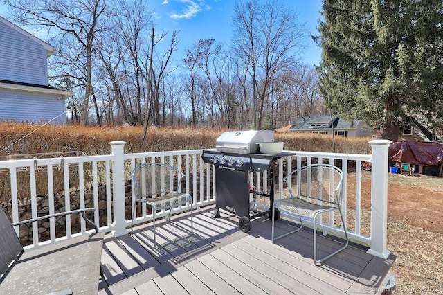 wooden terrace with a grill
