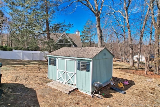 view of shed with fence
