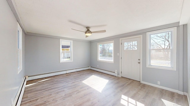 entryway with wood finished floors, a ceiling fan, a baseboard heating unit, baseboards, and baseboard heating
