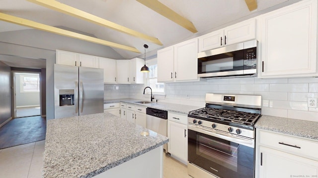 kitchen with stainless steel appliances, vaulted ceiling with beams, a sink, light stone countertops, and decorative backsplash