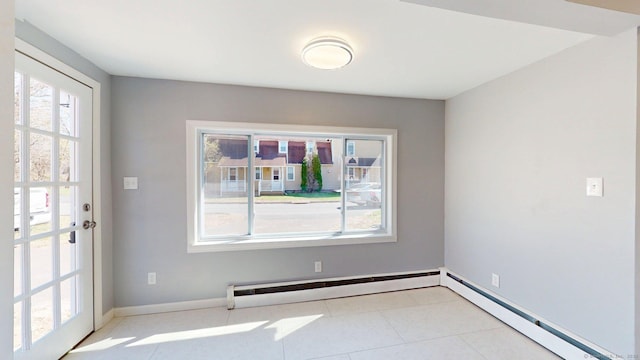 interior space with a baseboard radiator, baseboards, and tile patterned floors