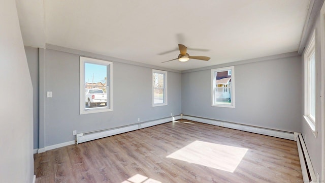 empty room with a baseboard radiator, wood finished floors, a ceiling fan, and baseboard heating