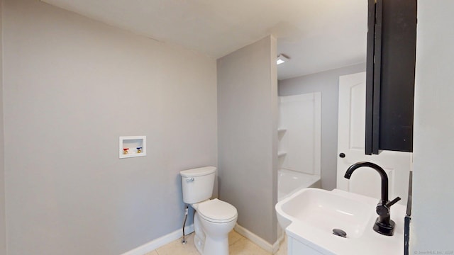bathroom with toilet, vanity, tile patterned floors, and baseboards