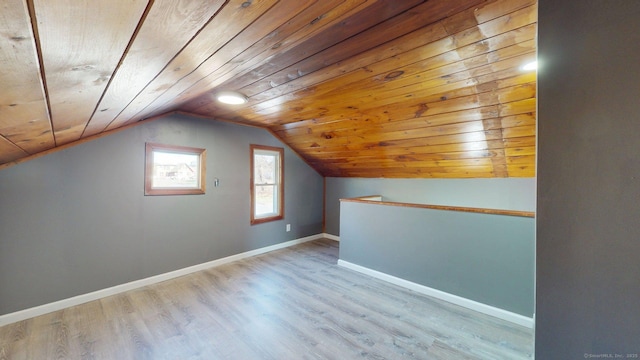 bonus room with wood ceiling, vaulted ceiling, wood finished floors, and baseboards