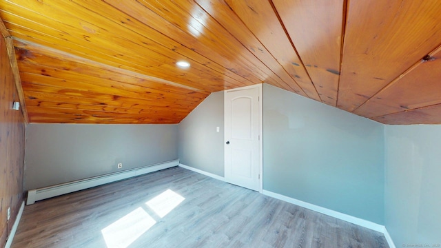 additional living space with a baseboard radiator, wood finished floors, baseboards, wooden ceiling, and lofted ceiling