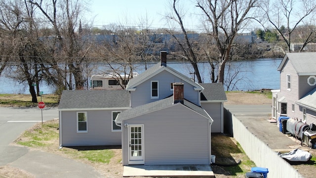 exterior space with fence and a shingled roof