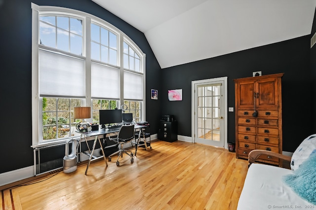 office area featuring lofted ceiling, wood finished floors, and baseboards