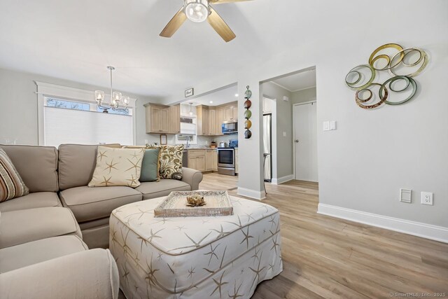 76 Carriage Path S Unit 76, Milford, CT 06460 - living room featuring ceiling fan with notable chandelier, light wood-style floors, and baseboards