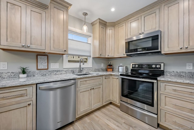 76 Carriage Path S Unit 76, Milford, CT 06460 - kitchen with light wood finished floors, light brown cabinets, a sink, and stainless steel appliances