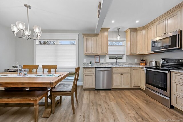 76 Carriage Path S Unit 76, Milford, CT 06460 - kitchen featuring a chandelier, appliances with stainless steel finishes, a sink, light wood-type flooring, and light brown cabinetry