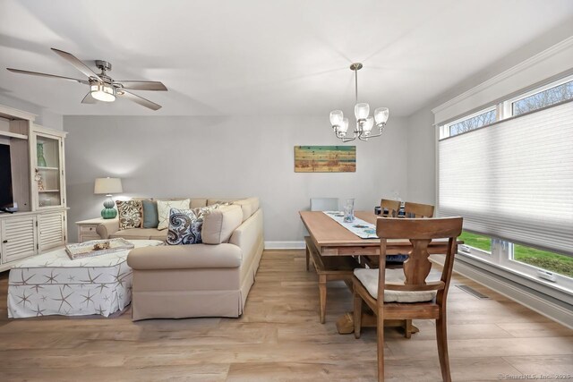 76 Carriage Path S Unit 76, Milford, CT 06460 - dining room with ceiling fan with notable chandelier, light wood-style flooring, and baseboards
