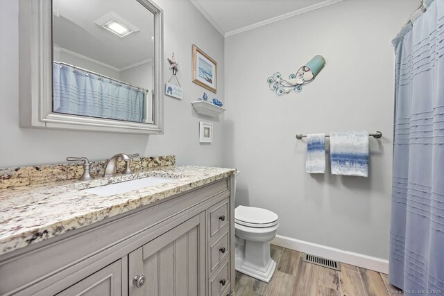 76 Carriage Path S Unit 76, Milford, CT 06460 - bathroom with vanity, wood finished floors, baseboards, visible vents, and ornamental molding