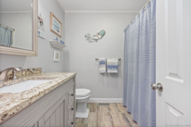 76 Carriage Path S Unit 76, Milford, CT 06460 - bathroom featuring visible vents, baseboards, ornamental molding, wood finished floors, and toilet