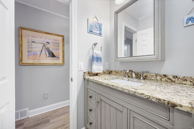76 Carriage Path S Unit 76, Milford, CT 06460 - bathroom featuring baseboards, visible vents, vanity, and wood finished floors