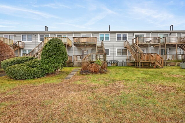 76 Carriage Path S Unit 76, Milford, CT 06460 - rear view of property with a lawn, central AC, stairway, and a deck