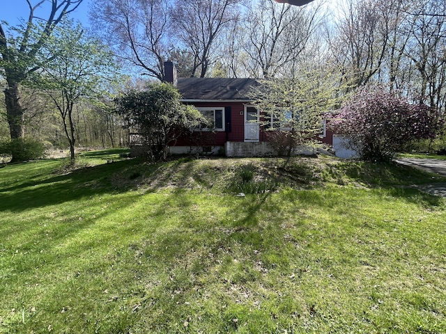 view of front of home with a front yard and a chimney