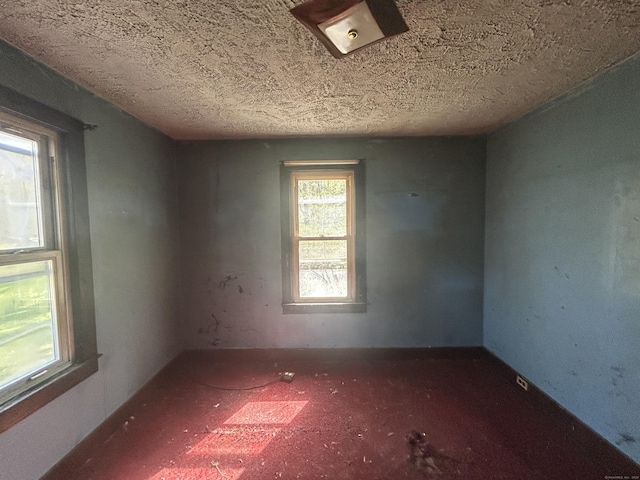 empty room with a textured ceiling
