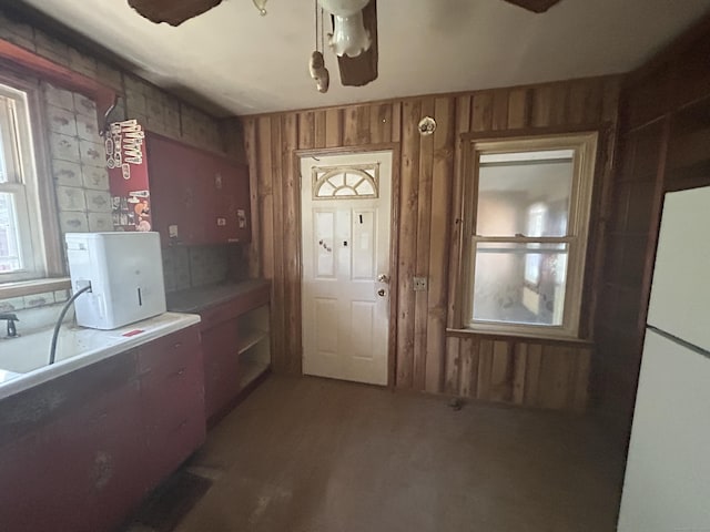 entryway with wood walls