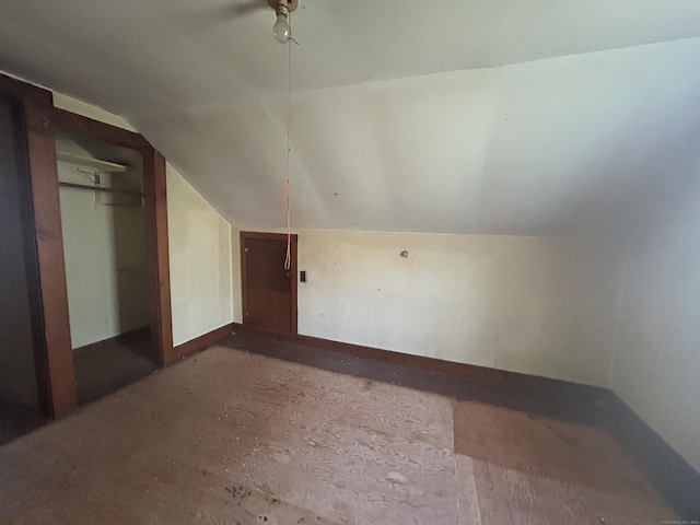 bonus room featuring vaulted ceiling and baseboards