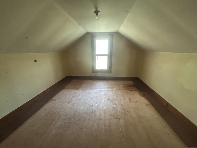 bonus room featuring baseboards and lofted ceiling