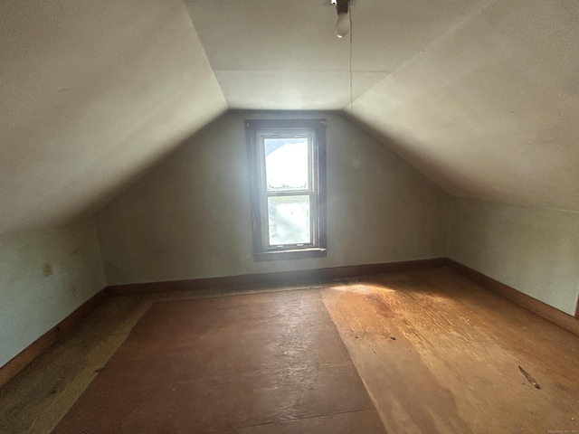 bonus room with lofted ceiling, wood finished floors, and baseboards